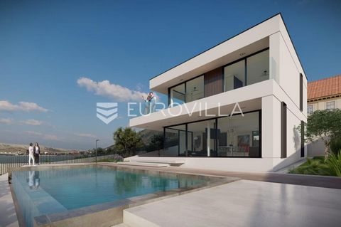Zadar, Pag, modern and luxurious villa is located first row by the sea, on a plot of 521 m2. The villa is spread over two floors. The ground floor consists of an entrance area, a modern kitchen and dining room (26.38 m2), a spacious living room of 22...